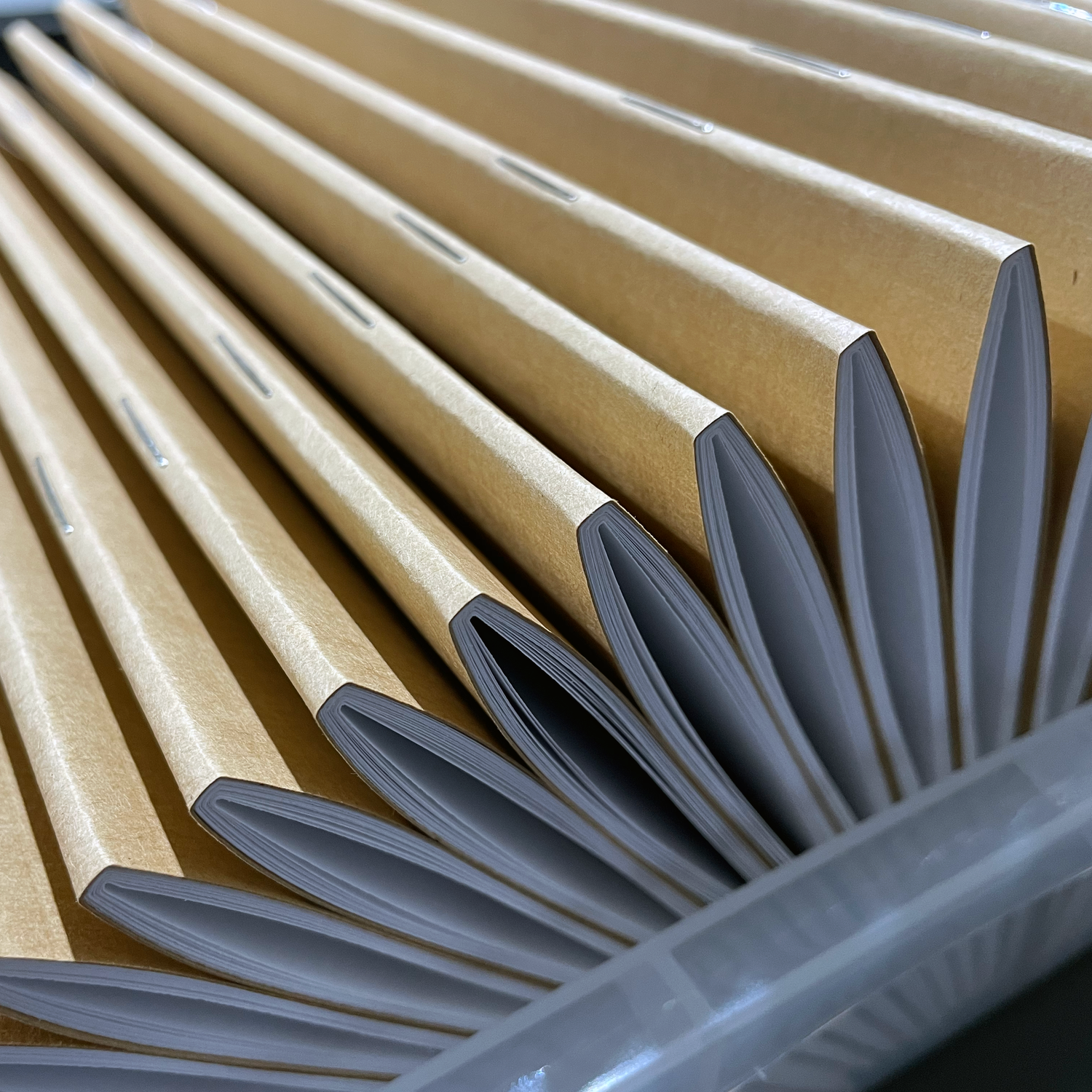 Spine of perfect-stapled custom notebook bulk wholesale order in production 