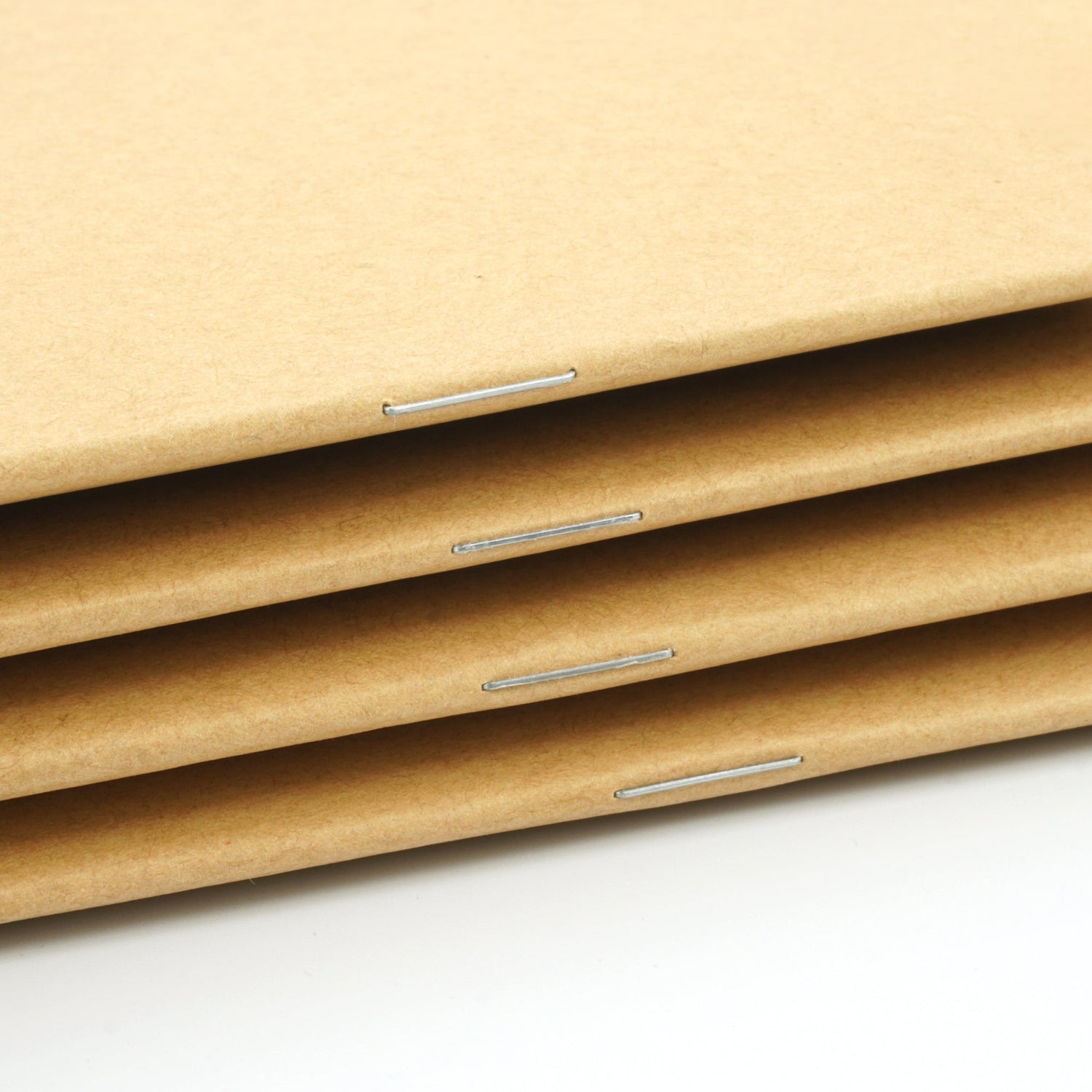 Standard stapled spine to secure pages in the notebook