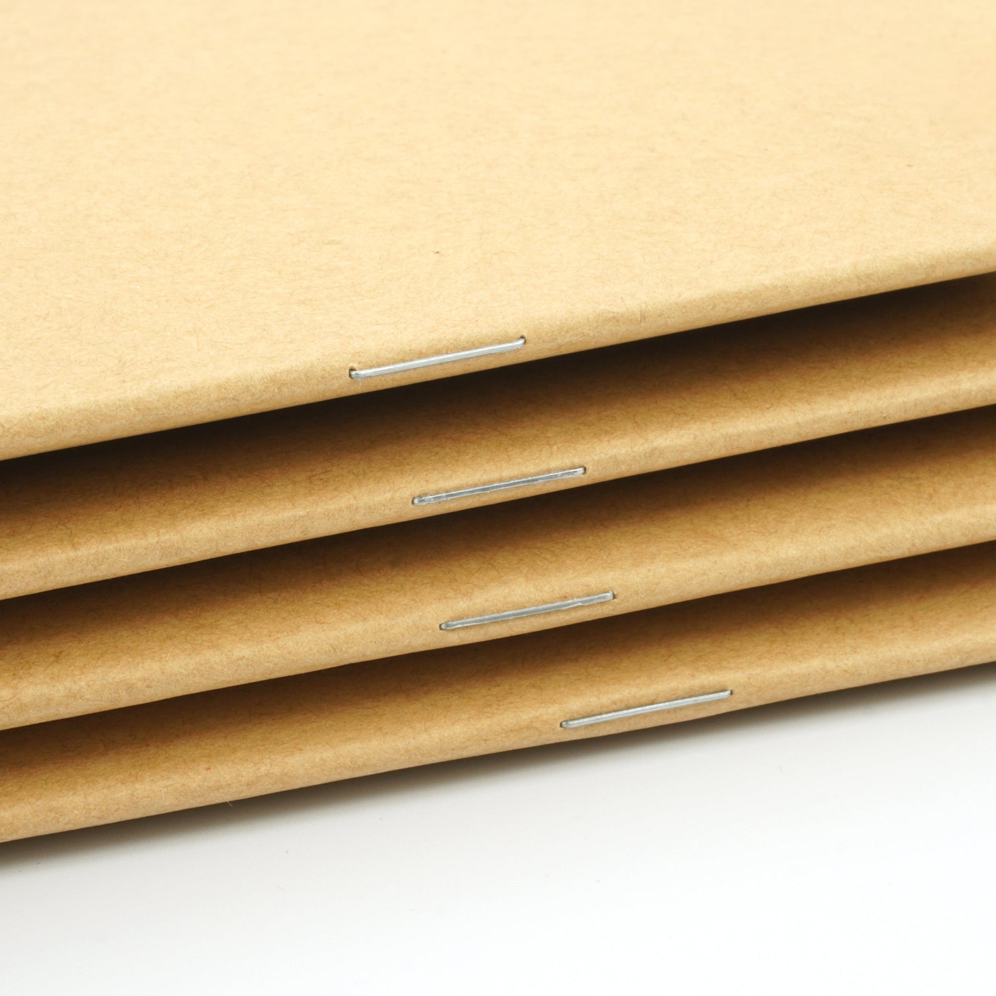 Standard stapled spine to secure pages in the notebook
